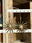Gold toned brass sun earrings