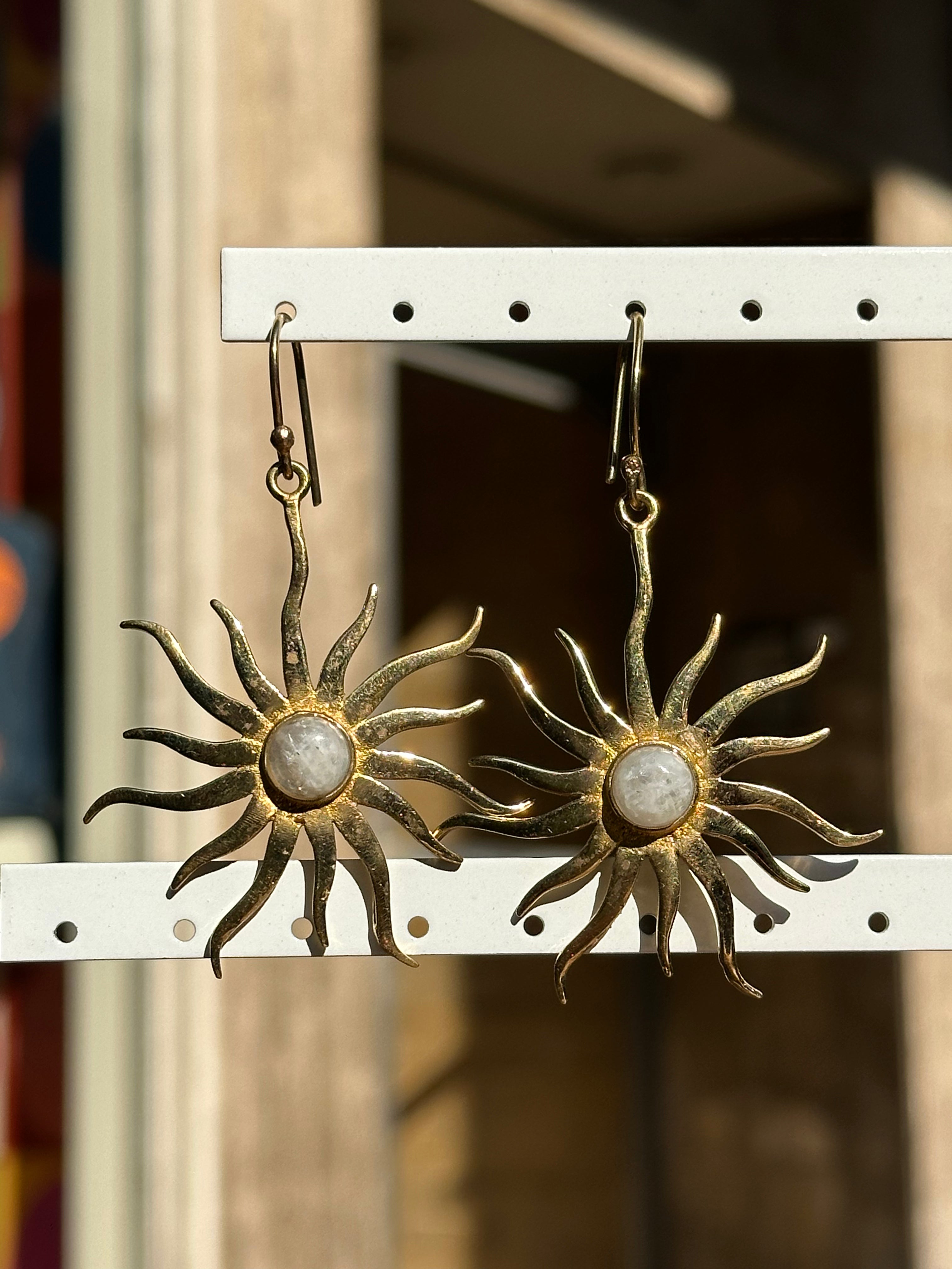 Gold toned brass sun earrings