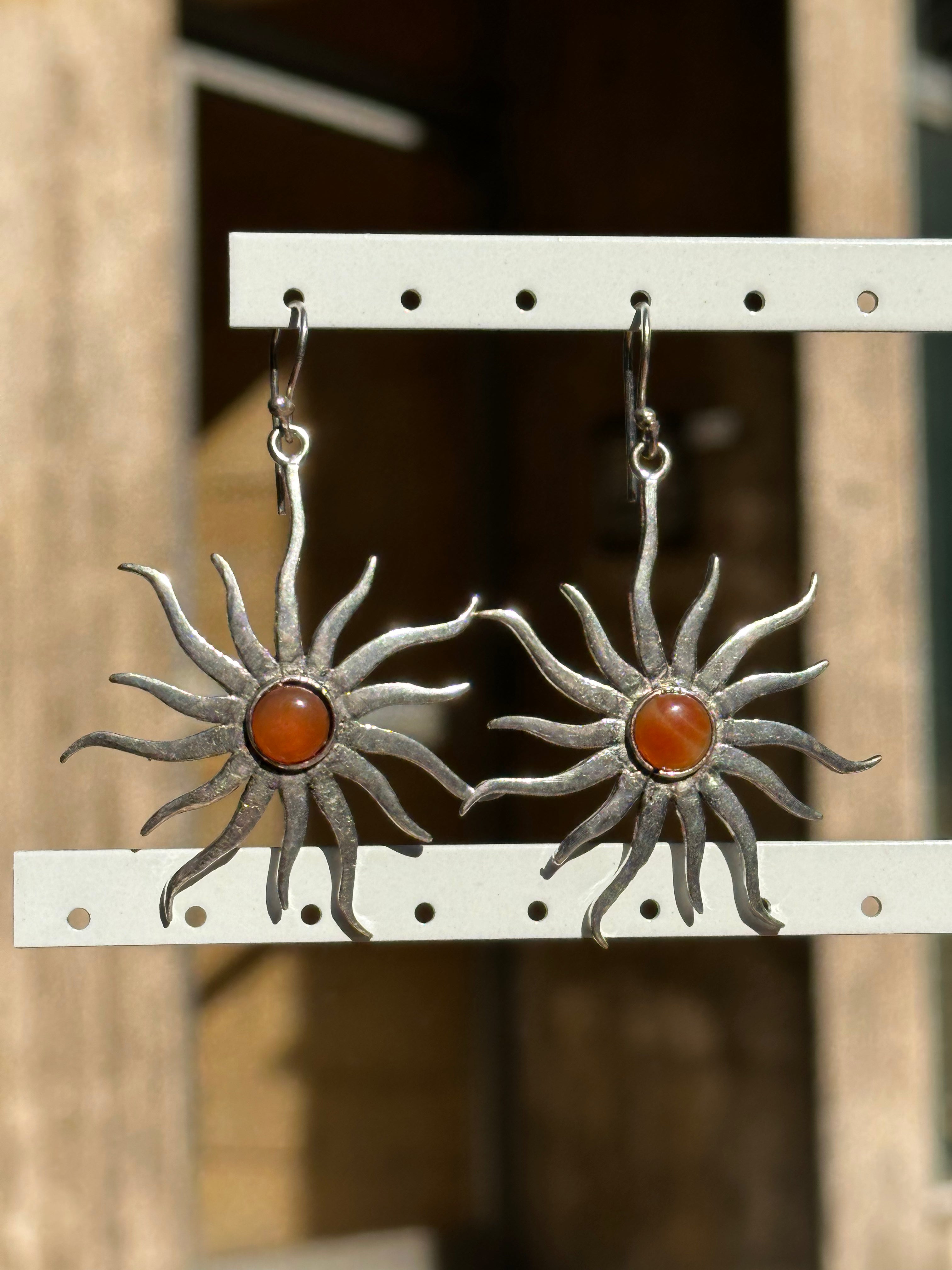 Silver toned brass sun earrings