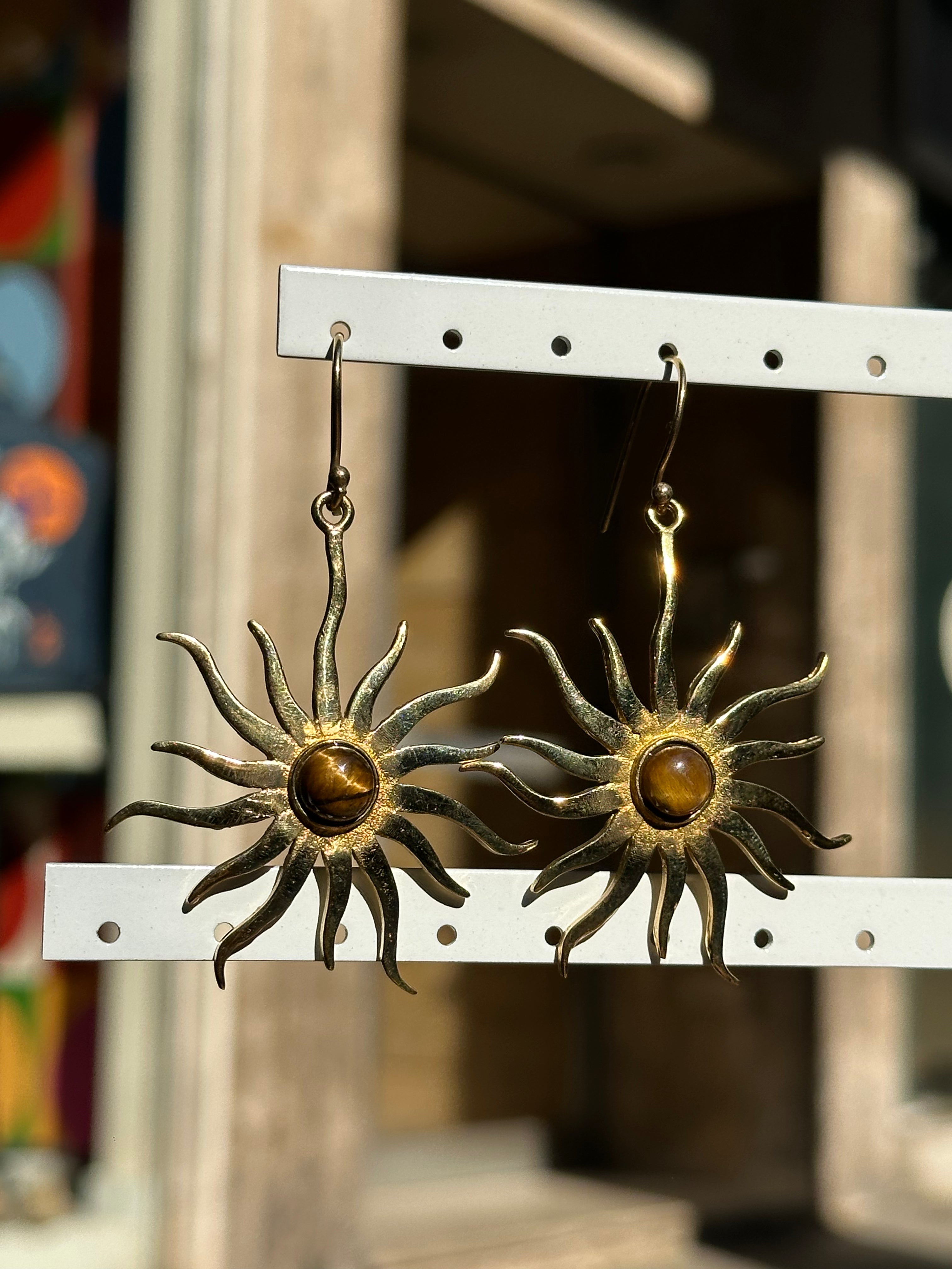 Gold toned brass sun earrings