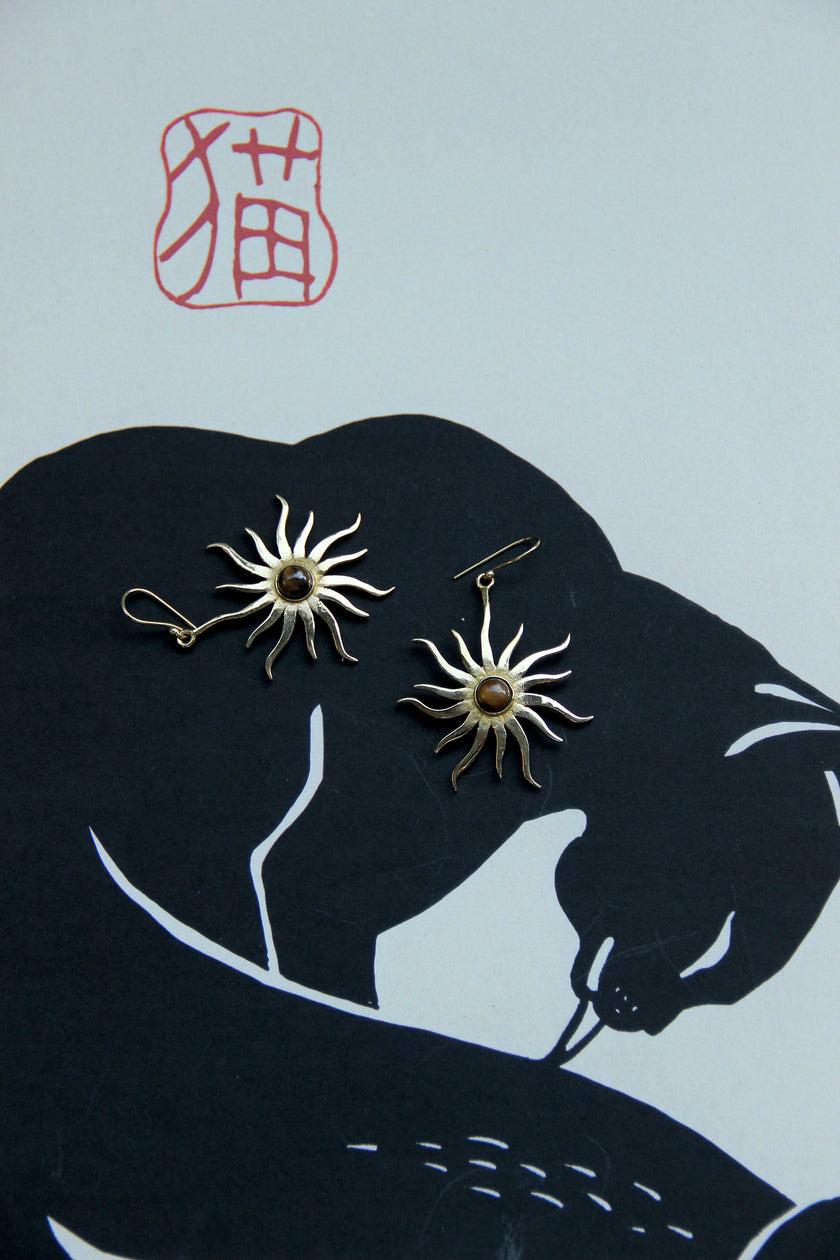 Gold toned brass sun earrings