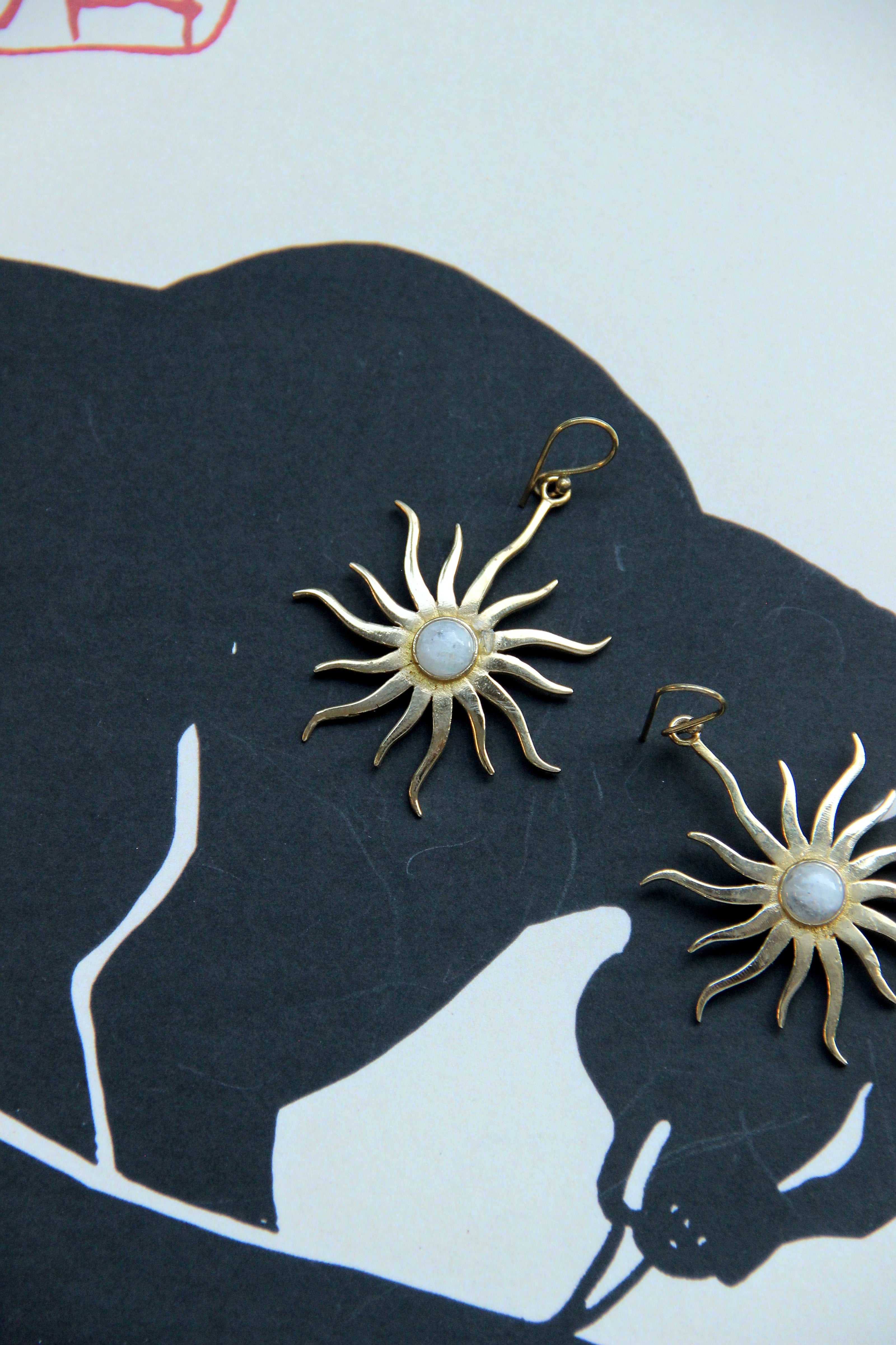Gold toned brass sun earrings