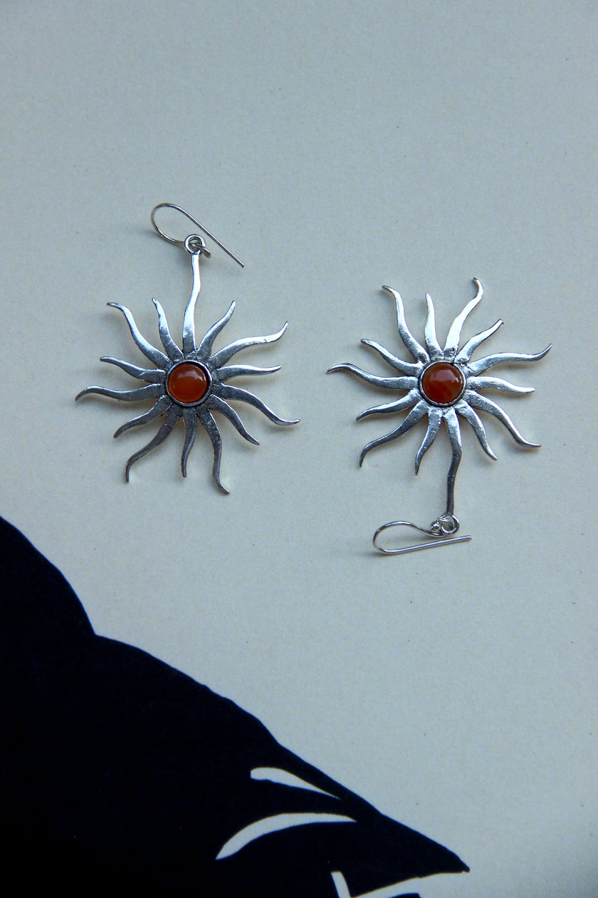 Silver toned brass sun earrings