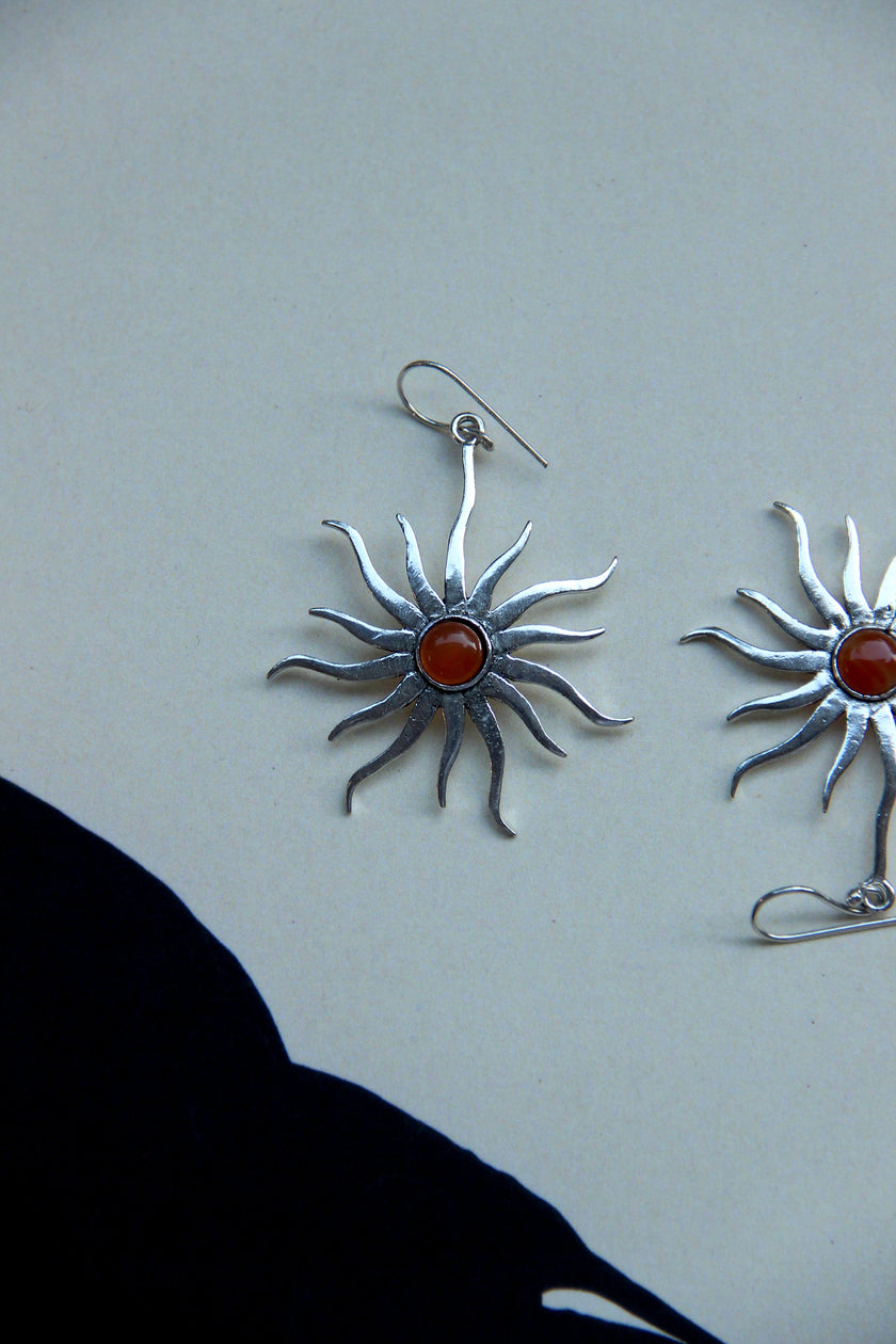 Silver toned brass sun earrings