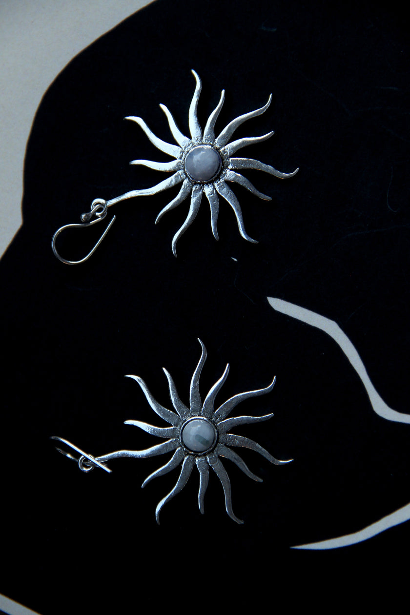 Silver toned brass sun earrings