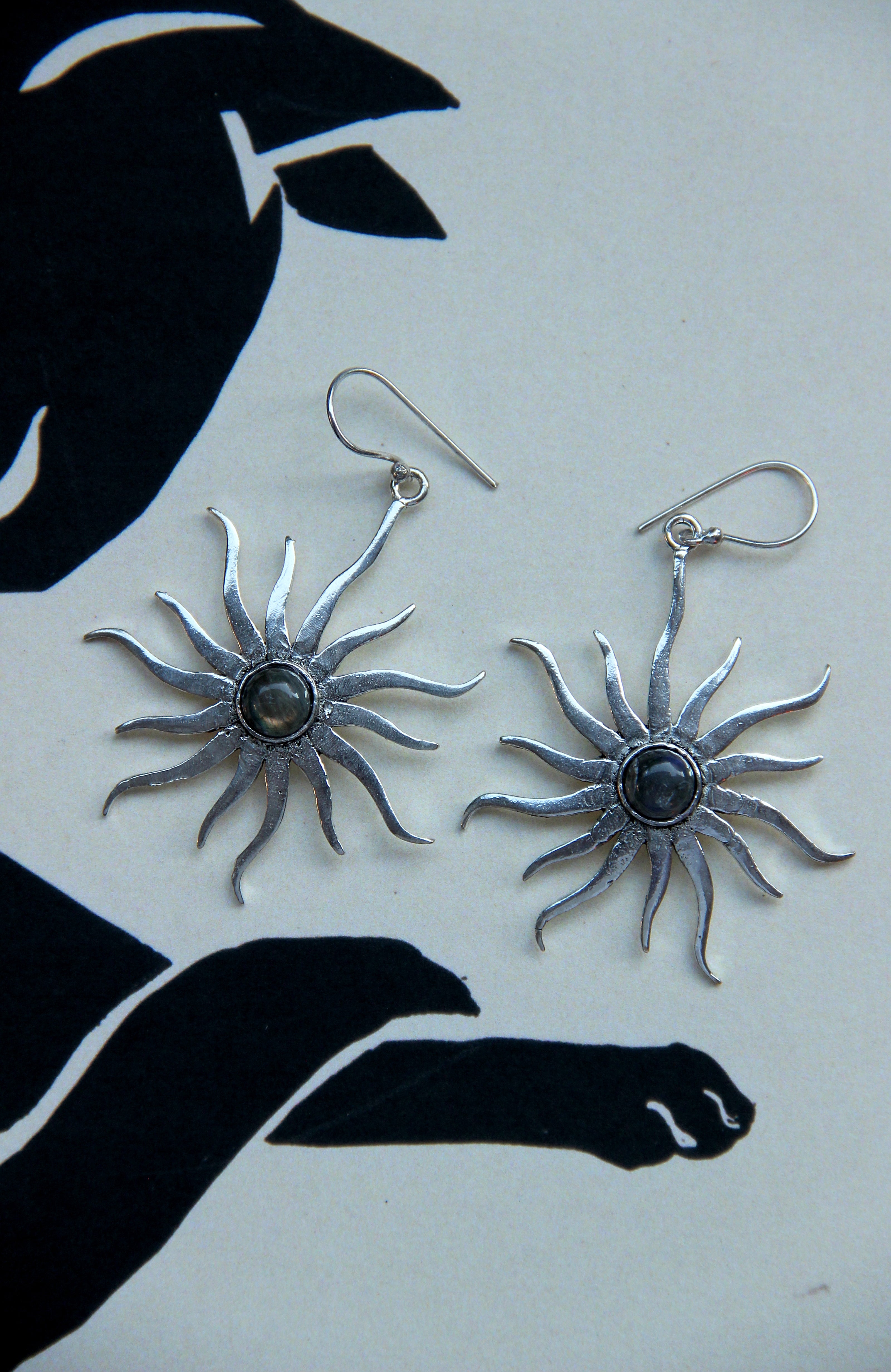 Silver toned brass sun earrings