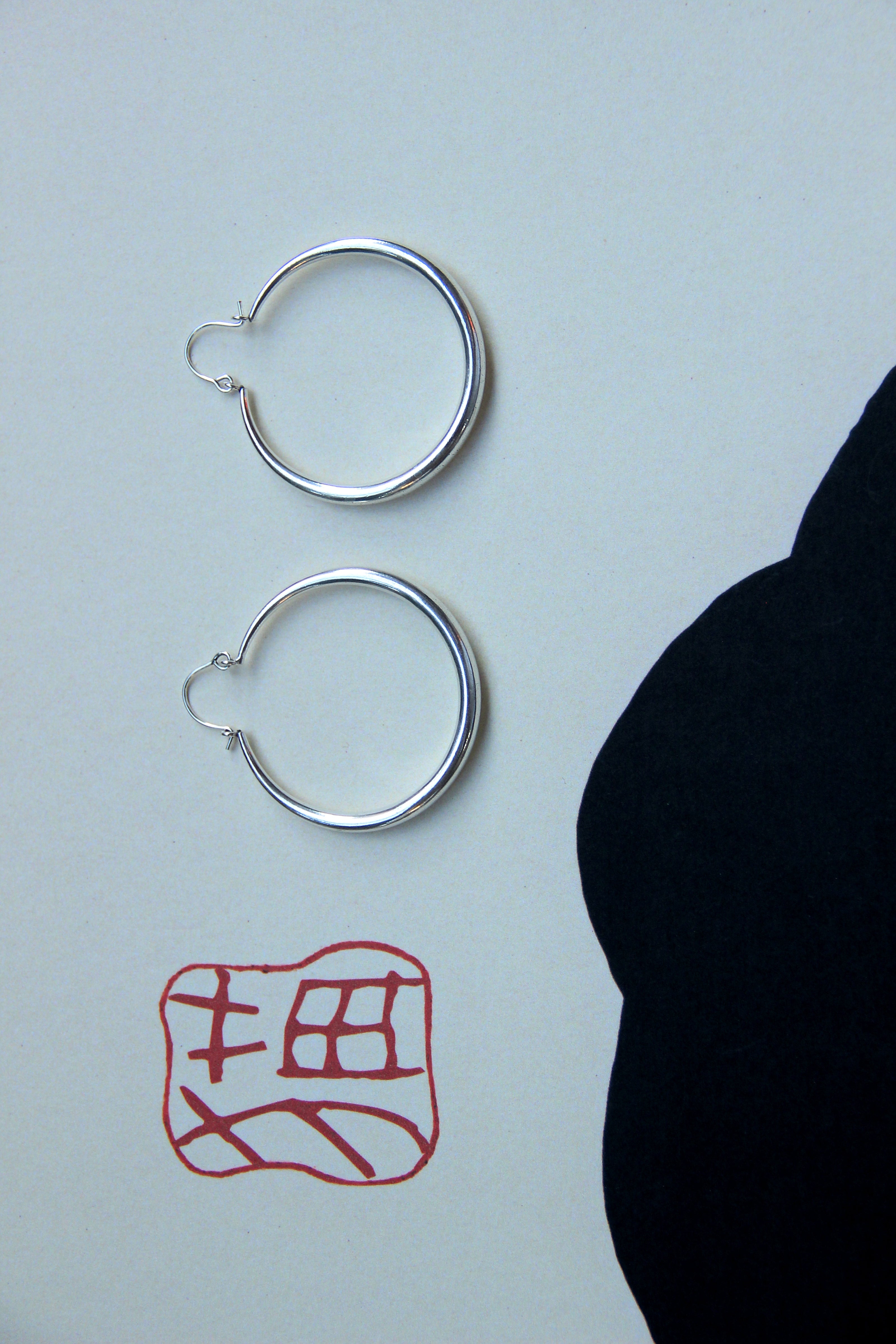 Silver toned brass hoop earrings